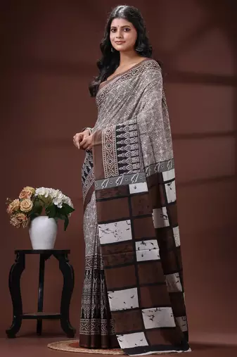 Coffee brown  malmal cotton saree in ethnic batik print with geometric block pallu