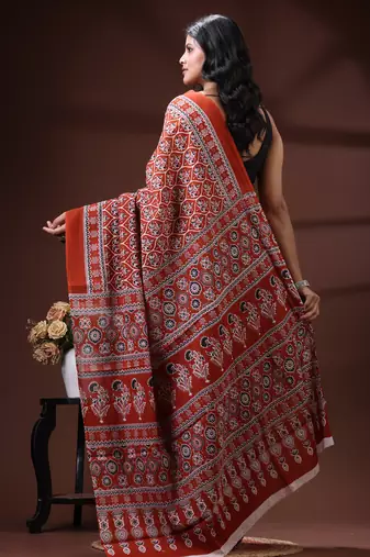 Rust red  malmal cotton saree with all-over traditional hand-block prints and panelled pallu