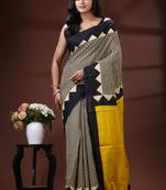 Bold geometric malmal cotton saree in black & cream with vibrant yellow block borders