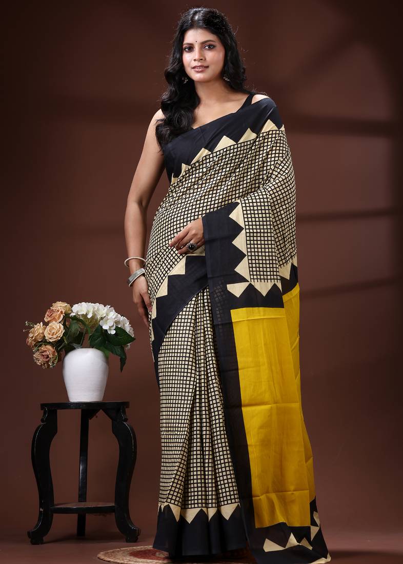 Bold geometric malmal cotton saree in black & cream with vibrant yellow block borders