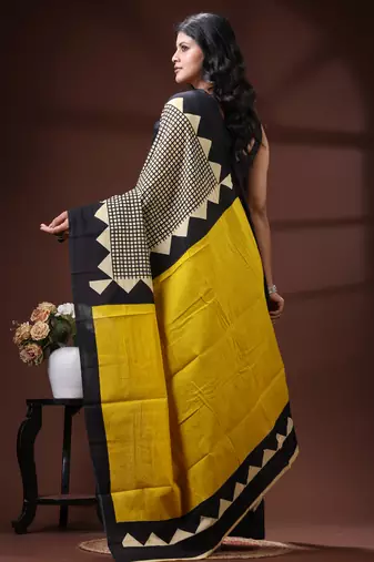 Bold geometric malmal cotton saree in black & cream with vibrant yellow block borders