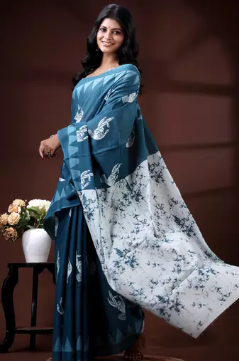 Ocean teal malmal cotton saree with white bird motifs and geometric temple border prints
