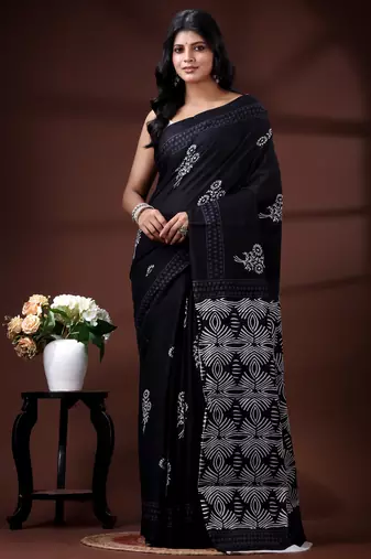 Jet black  malmal cotton saree with white floral butis and ornate geometric pallu