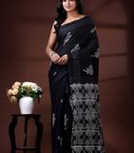 Jet black  malmal cotton saree with white floral butis and ornate geometric pallu