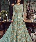 Soft premium net party wear readymade gown in turquoise color with zari with stone work