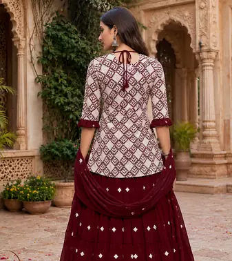 Maroon Elegant Embroidered Kurti With Flowy Sharara And Soft Net Dupatta Perfect For Festive And Wedding Looks