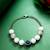 white beaded evil eye bracelet