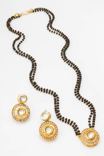 gold-tone ganesh pendant and leaf chain mangalsutra set with ad stone paan pendant and earrings