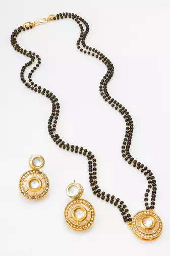 gold-tone ganesh pendant and leaf chain mangalsutra set with ad stone paan pendant and earrings