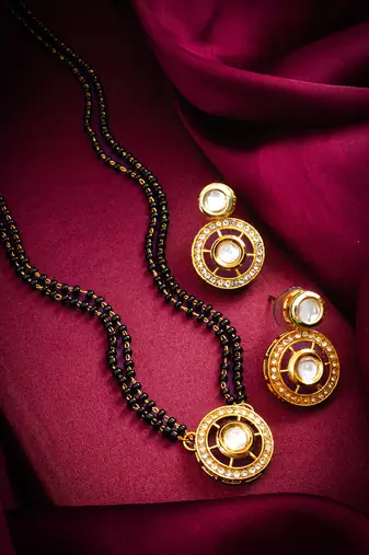 gold-tone ganesh pendant and leaf chain mangalsutra set with ad stone paan pendant and earrings