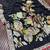 black meenakari figure flower georgette saree