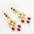 gold plated multi-color kundan and red bead long drop earrings