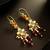 gold plated multi-color kundan and red bead long drop earrings