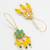 long hook green floral earrings with yellow bead clusters and pearl accents