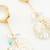 crystal bloom long leaf earrings in gold finish