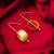gold-plated textured cylindrical scroll hoop earrings with hook closure