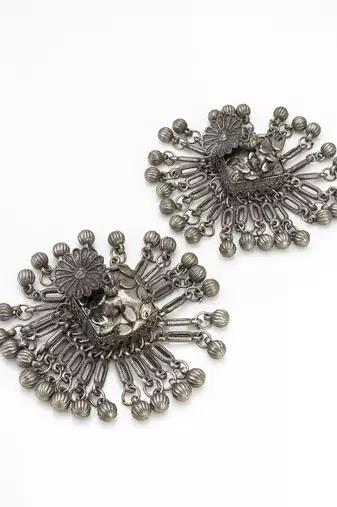 oxidized silver starburst jhumka earrings with ribbed ghungroo fringe and floral stud