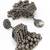 oxidized silver starburst jhumka earrings with ribbed ghungroo fringe and floral stud