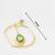 gold-plated octagon frame drop earrings with green stone