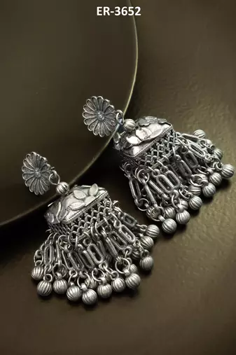 oxidized silver starburst jhumka earrings with ribbed ghungroo fringe and floral stud