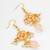 gold-toned peach floral earrings with pearl drops and crystal dangle
