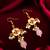 gold-toned floral earrings with stone, pearl drops