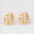 gold-plated circular swirl stud earrings with ad stone