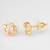 gold-plated circular swirl stud earrings with ad stone