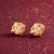 gold-plated circular swirl stud earrings with ad stone