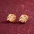 gold-plated circular swirl stud earrings with ad stone
