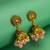 peacock motif pink beaded gold plated jhumka earrings