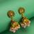 peacock motif pink beaded gold plated jhumka earrings