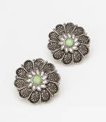 oxidized floral motif stud earrings with green stone
