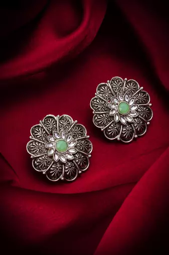 oxidized floral motif stud earrings with green stone