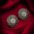 oxidized floral motif stud earrings with green stone