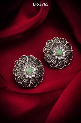 oxidized floral motif stud earrings with green stone