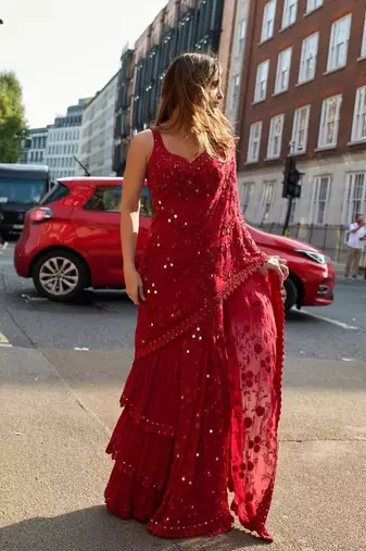 Red georgette embroidered saree with mirror work and ruffled skirt