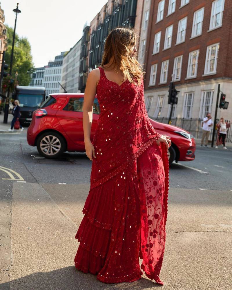 Red georgette embroidered saree with mirror work and ruffled skirt