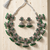 Oxidized silver-tone lotus motif jhumki necklace set with emerald-green accents