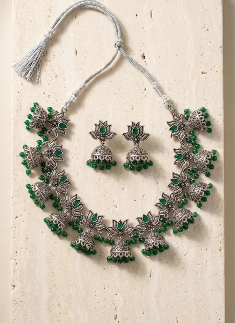 Oxidized silver-tone lotus motif jhumki necklace set with emerald-green accents