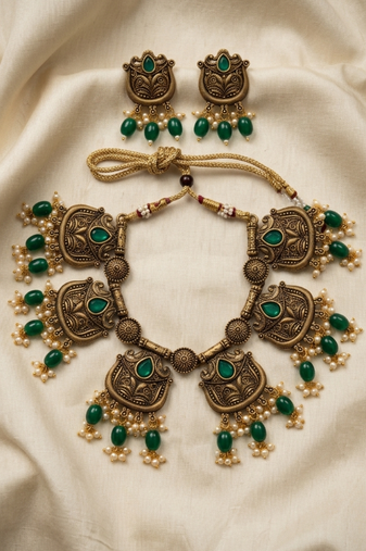 Gold plated-tone lotus motif jhumki necklace set with emerald-green accents
