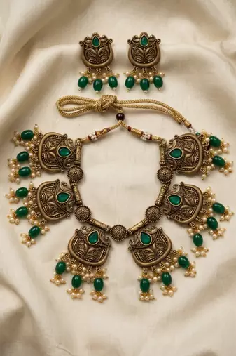 Gold plated-tone lotus motif jhumki necklace set with emerald-green accents
