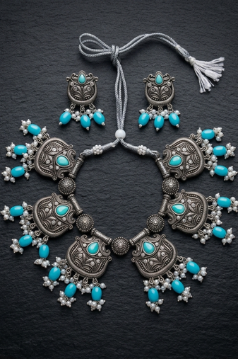 Oxidized silver-tone lotus motif jhumki necklace set with sapphire-blue accents