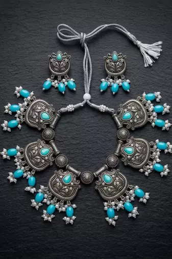 Oxidized silver-tone lotus motif jhumki necklace set with sapphire-blue accents