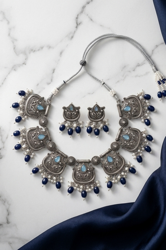 Oxidized silver-tone lotus motif jhumki necklace set with blue accents