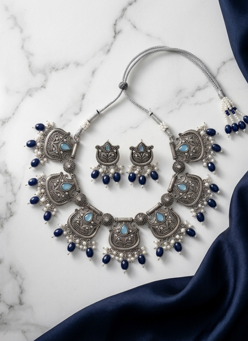 Oxidized silver-tone lotus motif jhumki necklace set with blue accents