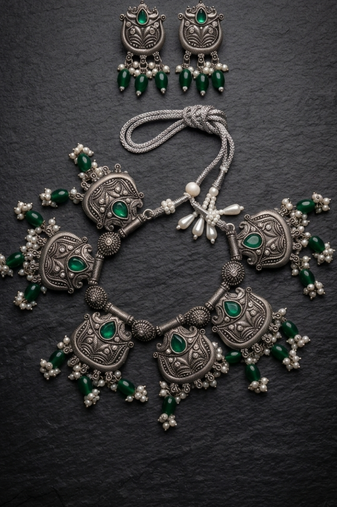 Oxidized silver-tone lotus motif jhumki necklace set with emerald-green accents