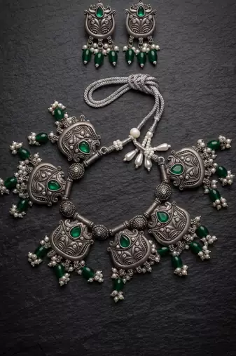 Oxidized silver-tone lotus motif jhumki necklace set with emerald-green accents