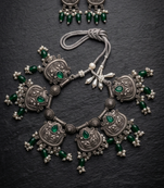 Oxidized silver-tone lotus motif jhumki necklace set with emerald-green accents