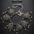 Oxidized silver-tone lotus motif jhumki necklace set with emerald-green accents